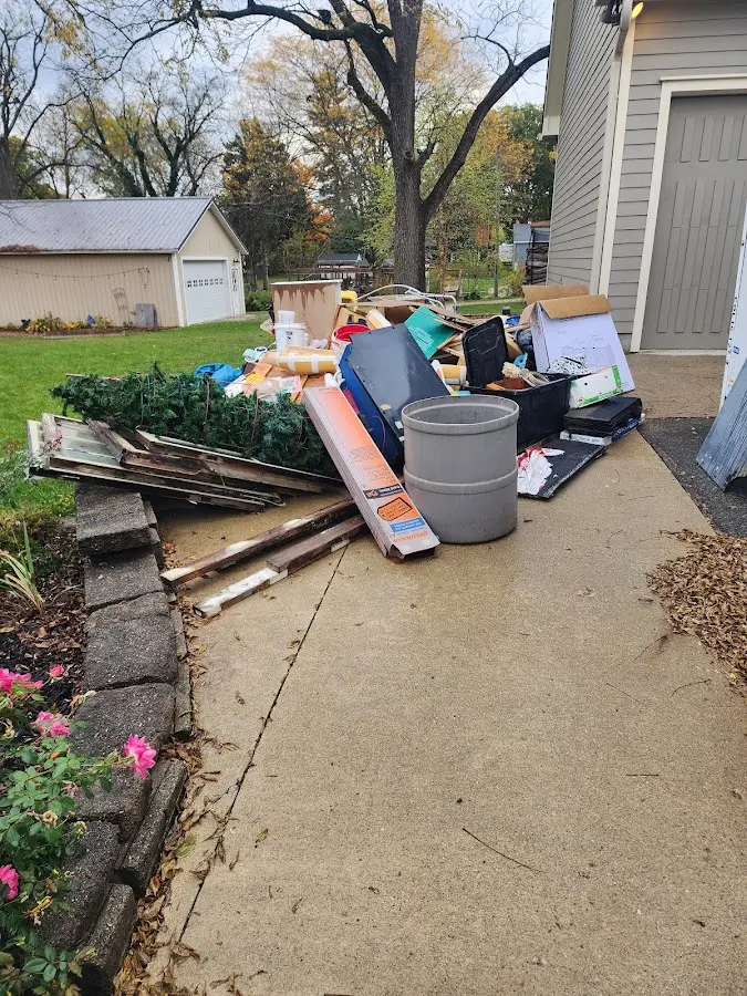 Dumpster being loaded with debris for Estate Cleanout Dumpster Rental in Long Beach